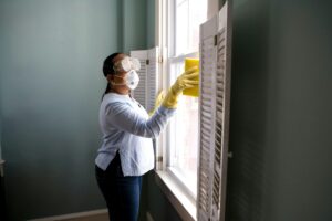 Professional home cleaning service with housekeeper cleaning a kitchen